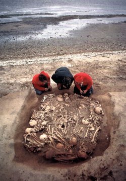 A mass human grave uncovered at a beach